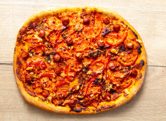 Pizza with tomatoes and sausage