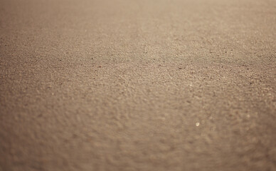 Absolutely flat sandy surface. Short focus on the central part with blurring in the foreground and background.