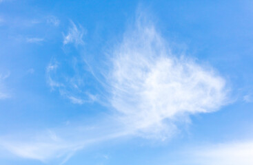 Naklejka na ściany i meble White clouds on a blue sky as background