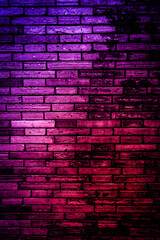 Neon light on brick walls that are not plastered background and texture. Lighting effect red and...