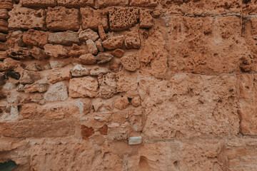 Stone wall texture/background,historical old ancient stone,preserved to our time, stones are laid evenly, solid construction has been standing for many centuries,ancient buildings,buildings and ruins