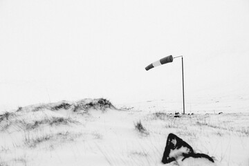 Windsock waving in snowy countryside