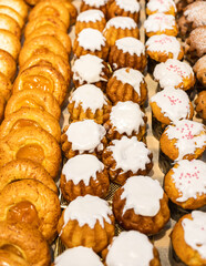 a lot of buns with different fillings and toppings are on the counter. High quality photo