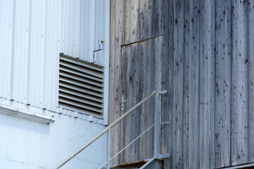 An old rusted silo photographed in a port area in summer