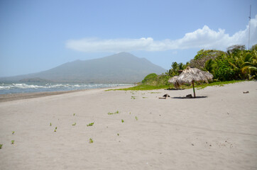 Relaxing beach in Ometepe Island in Nicaragua. Beach on a lake with the view on a volcano in the background