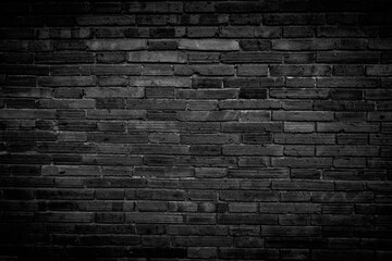Plakat Black brick walls that are not plastered background and texture. The texture of the brick is black. Background of empty brick basement wall.