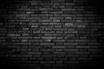 Fototapeta na wymiar Black brick walls that are not plastered background and texture. The texture of the brick is black. Background of empty brick basement wall.