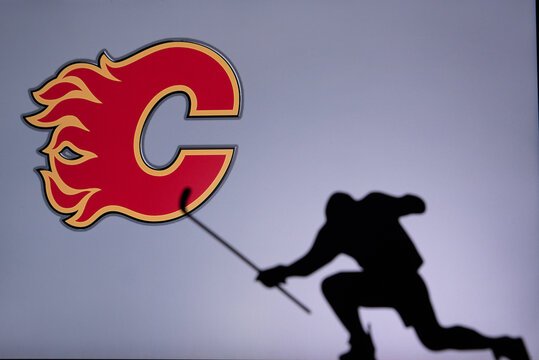 TORONTO, CANADA, 17. JULY: Calgary Flames Logo. Professional NHL hockey player celebrate goal. Silhouette photo, Edit space