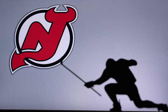 TORONTO, CANADA, 17. JULY: New Jersey Devils Logo. Professional NHL hockey player celebrate goal. Silhouette photo, Edit space