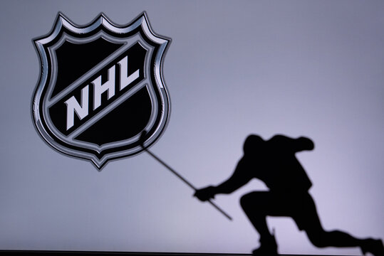 TORONTO, CANADA, 17. JULY: National Hockey League Logo. Professional NHL hockey player celebrate goal. Silhouette photo, Edit space
