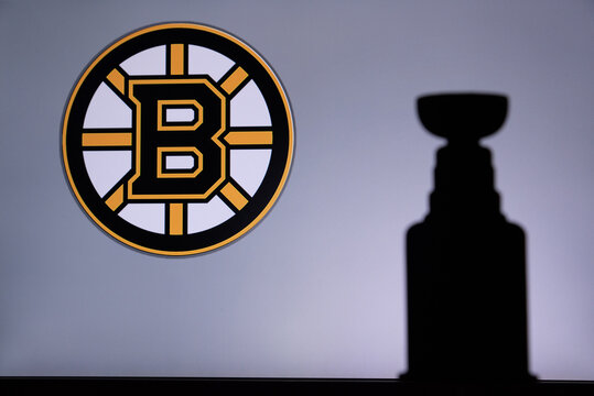 TORONTO, CANADA, 17. JULY: Boston BruinsLogo of NHL club on the screen. Stenley Cup Trophy Silhouette.