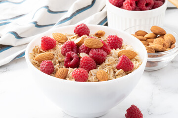 bowl of oatmeal with raspberries and almonds