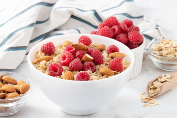 bowl of oatmeal with raspberries and almonds