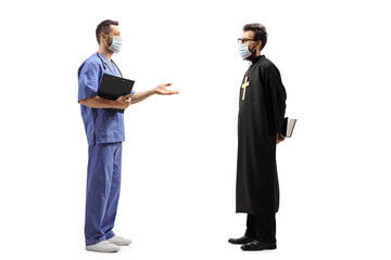 Male doctor and a priest wearing face masks and having a conversation