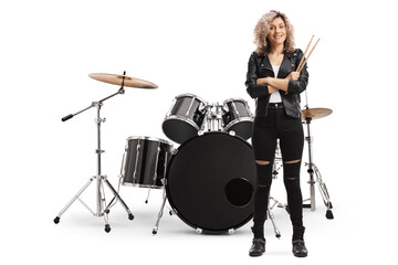 Obraz na płótnie Canvas Young woman drummer holding drumsticks