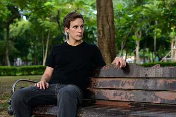 Fototapeta premium Portrait of young handsome man at the park