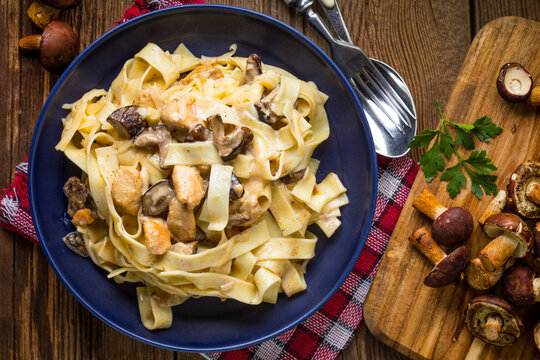 Tagliatelle pasta with forest mushrooms and chicken.