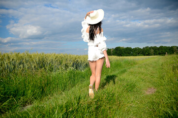 Female with summer hat in farmland