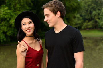 Obraz premium Portrait of multi ethnic couple together and in love at the park