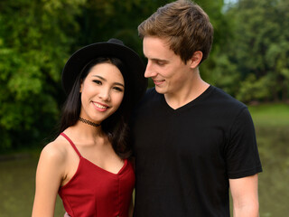 Obraz premium Portrait of multi ethnic couple together and in love at the park