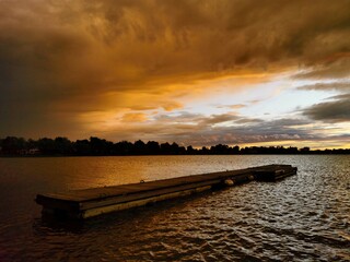 Obraz premium dock sunset over the river