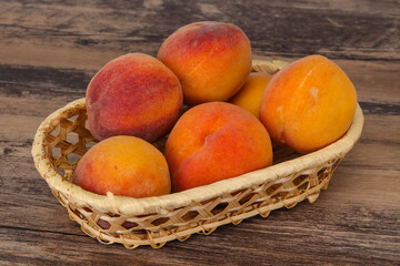 Peach heap in the wooden basket