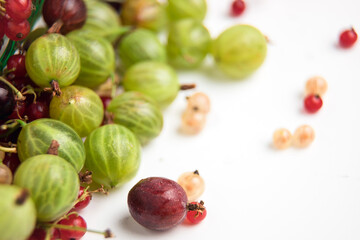 Red, black and white currants are isolated. Berries on a white background. Gooseberries are green and red. Assorted berries. Currant on a branch.