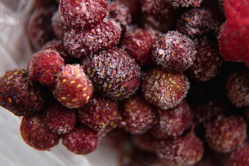 lots of frozen berries. wild strawberry. close up.