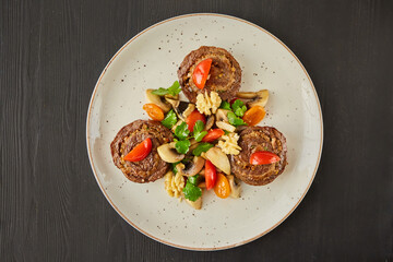 Pork, lamb or beef meatloaf with mushrooms, nuts, tomatoes and herbs. A dish from the chef