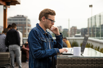 young man working on a laptop in cafe