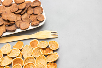 Cereal pancakes on gray background and wooden fork