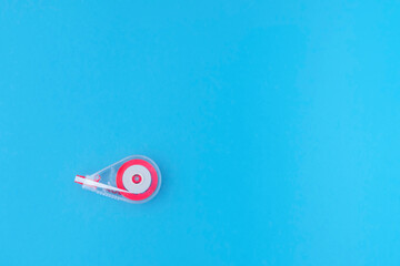 correction tape on a blue background. Office stationery.