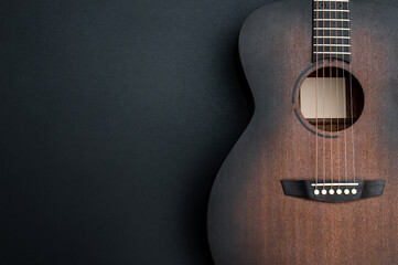 Acoustic guitar on black background. Space for text. - 365553188