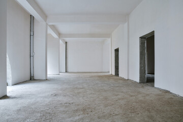 Unfinished building interior, white room.Repairs in the apartment. Preparing in the commercial...