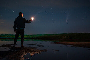 man with a lantern in the dark watches the starry sky © pazyuk