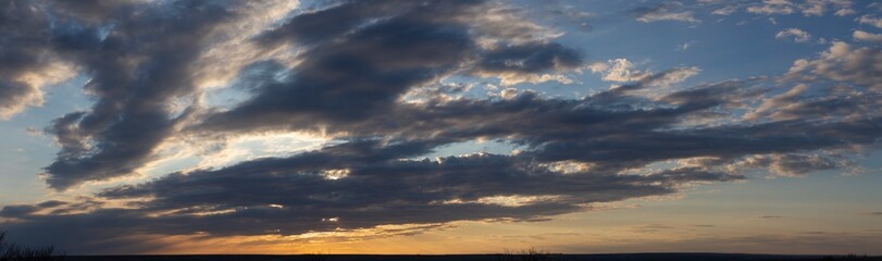 Purple-magenta clouds. Cirrus cloudscape on blue sky.Tragic gloomy sky. Landscape with bloody sunset. Fantastic skies on the planet earth.