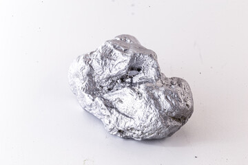 Macro shot of nickel metal ore piece isolated on a white background. Closeup photo of surprising...