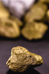 rough gold stones, precious nuggets isolated on black background.