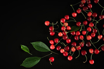 Red cherries on black background. Tasty fruit. Top view.