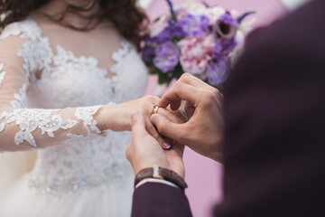 Fototapeta premium Groom wears the ring bride.