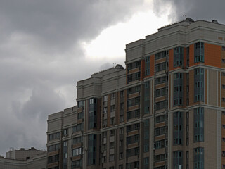 elements of multi-storey residential buildings in the background sky.