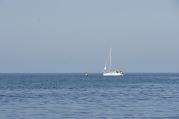 Obraz premium View of a white yacht over the calm blue sea