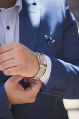 Businessman looking at his watch. Man hands and clock