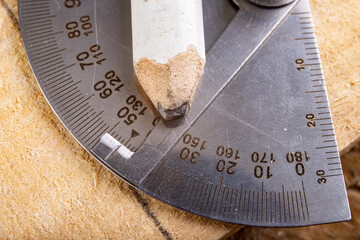 Metal protractor for measuring in carpentry. Minor work in a home workshop.