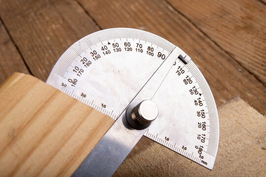 Metal protractor for measuring in carpentry. Minor work in a home workshop.