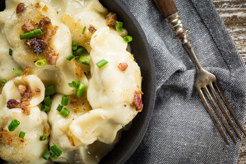 Fried dumplings (pierogi) with meat filling sprinkled with greaves.