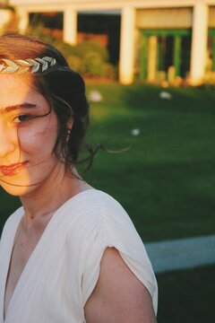 portrait of a young woman smiling in the sunset at graduation celebration party