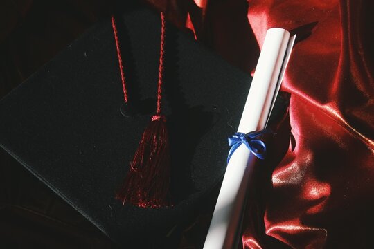 Graduation cap and diploma still life image