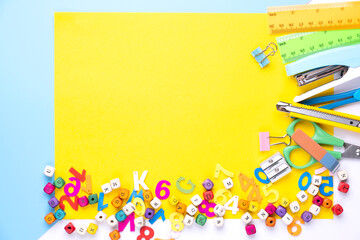 Many different school supplies on yellow copy space background. Back to school concept.