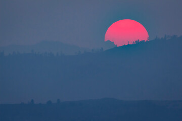 sunset in the foggy mountains